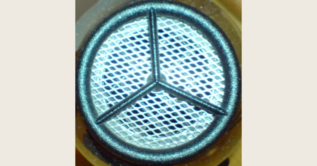 Close-up of a circular grille on a hair dryer; its body and handle are outside the frame
